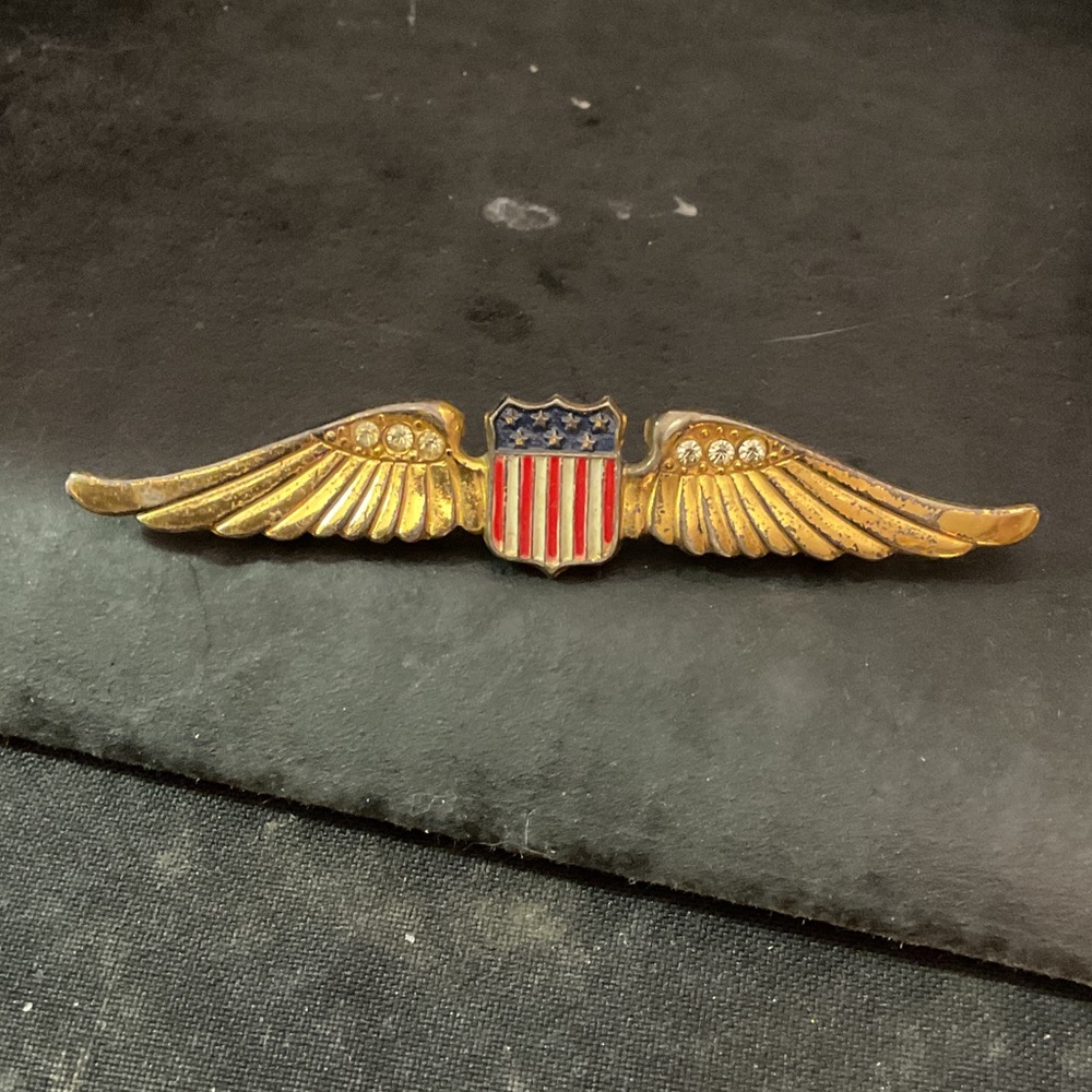 This is a World War II era U.S. Army Air Forces "sweetheart wings" brooch,